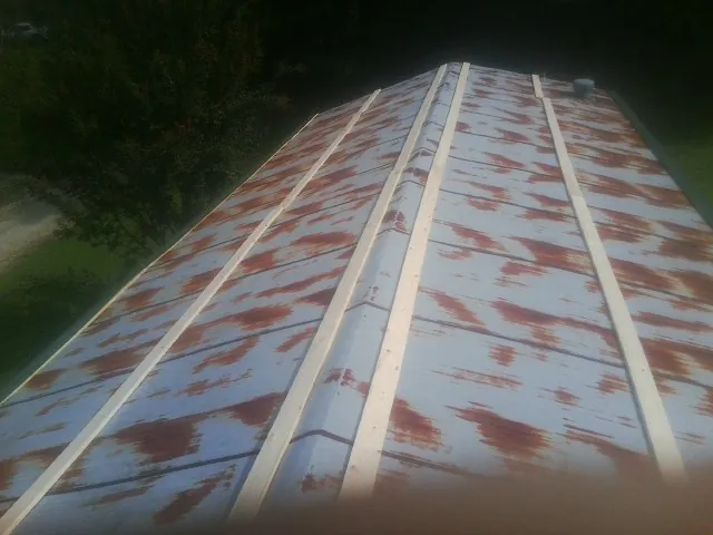Rusted metal roof panels with new wood purlins before replacement — Storm Damage Roof Repair in Port Carbon by Roofing Brothers