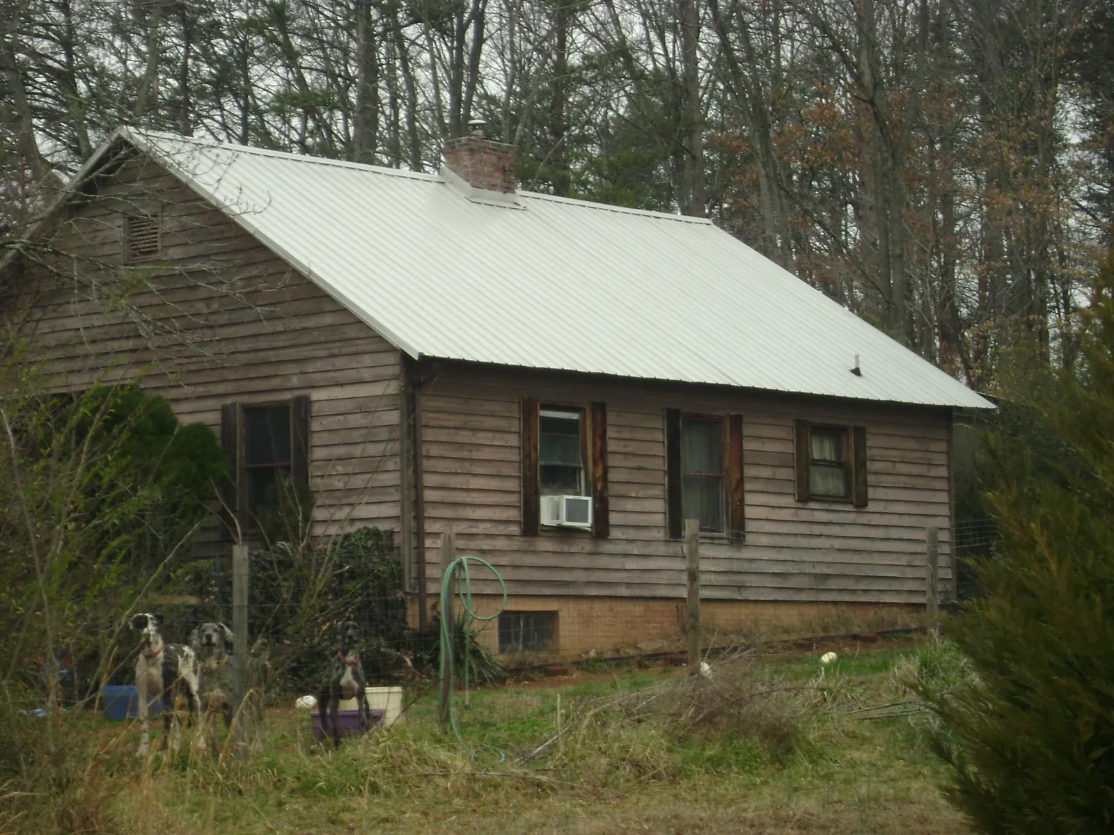 White metal roof on an old wood sided farmhouse, from a Metal Roof Installation job in Port Carbon
